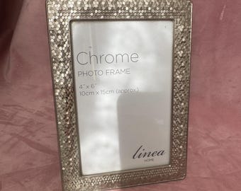 Unique silver tone photo frame.