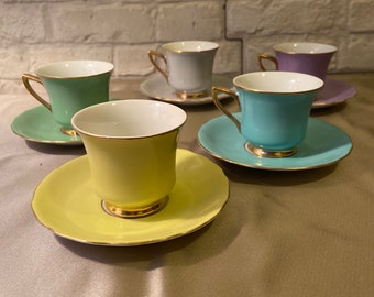 Vintage Beautiful set of 5 mini mugs and saucers.Cups and saucer all diferent colours.Gold ornaments.