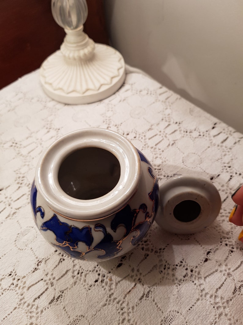 Vintage small lidded pot.Porcelain whit blue and gold flowers.