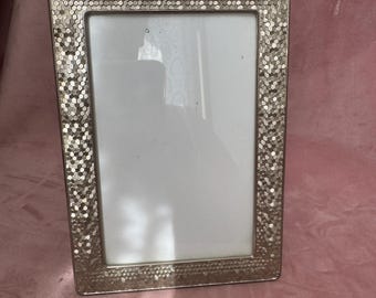 Unique silver tone photo frame.