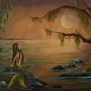 Acrylic painting of a mermaid sitting in the moonlight on a rock.  Water surrounds her. This painting was created by artist, Raine.  The tone of the artwork is warm and peaceful.  It is created with oranges, blues, green and browns. It is fantasy art