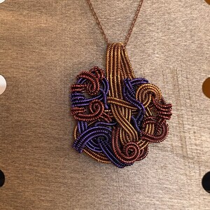 Copper pendant woven with three different colors of copper wire, hand made jewelry