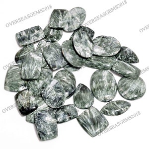 May include: A collection of green and silver gemstone cabochons. The stones have a unique, swirling pattern and are perfect for jewelry making.