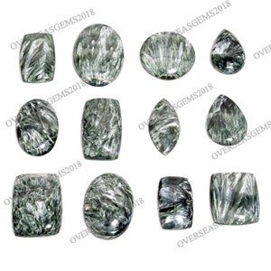 May include: A collection of ten green and black gemstone cabochons in various shapes, including oval, rectangle, and teardrop. The stones have a swirling, marbled pattern.