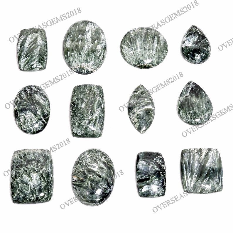 May include: A collection of ten green and black gemstone cabochons in various shapes, including oval, rectangle, and teardrop. The stones have a swirling, marbled pattern.
