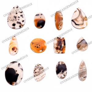 May include: Assortment of ten agate gemstone pendants in various shapes and sizes. The pendants are in shades of brown, white, and black with intricate patterns.