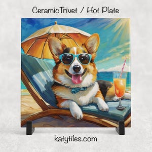 May include: Ceramic trivet featuring a corgi wearing sunglasses and a bow tie, relaxing on a beach chair under an umbrella. A cocktail sits nearby. The trivet has the text "Ceramic Trivet / Hot Plate" and "katytiles.com".