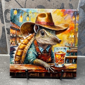 May include: A cartoon armadillo wearing a cowboy hat and overalls sits at a bar with a glass of whiskey. The armadillo has a shell on its back and is holding a glass of whiskey in its hand. The bar is made of wood and has a yellow and orange background.