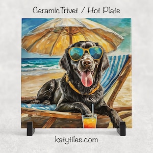May include: Square ceramic trivet featuring a black dog wearing sunglasses, relaxing on a beach chair under a yellow umbrella. The dog has its tongue out and is holding a drink. The background shows the ocean and sand. The text "katytiles.com" is at the bottom.