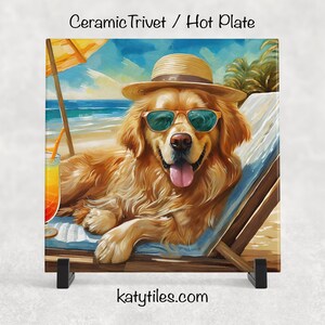 May include: A ceramic trivet or hot plate featuring a Golden Retriever wearing sunglasses and a hat, relaxing on a beach chair. The dog is depicted in a colorful, artistic style with a tropical drink nearby. The text "katytiles.com" is at the bottom.