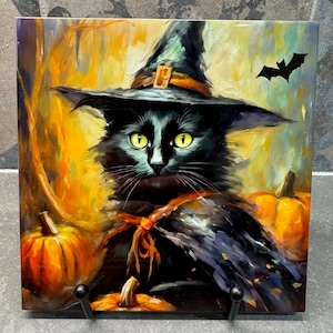 Puede incluir: Azulejo de cerámica cuadrado con un gato negro con sombrero de bruja, ojos amarillos y una cinta. El fondo es una escena otoñal cálida con calabazas y un murciélago, perfecto para la decoración de Halloween.