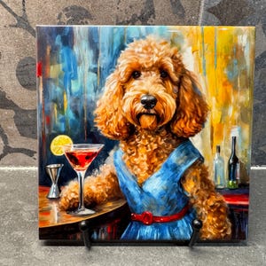 May include: Square ceramic tile featuring a poodle in a blue dress, red belt, and a cocktail. The dog is the focal point, set against a colorful, abstract background with a bar scene. A lemon slice adorns the drink.