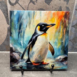 May include: A colorful painting of a penguin standing on a frozen lake. The penguin is painted in a realistic style with a white body, black wings, and a yellow beak. The background is a blue and green abstract design.