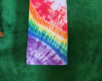 May include: A rainbow tie-dye fitted sheet with a white background. The sheet has a circular pattern in the center with a rainbow swirl design.