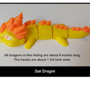May include: A yellow and orange Sun Dragon toy. The dragon is segmented, with a yellow body and orange accents on the head and spine. The text "Sun Dragon" is below the toy. The dragons are about 6 inches long.