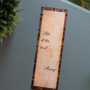 May include: A brown and white bookmark with a vintage newspaper design. The bookmark features the text "After all this time?" and "Always".