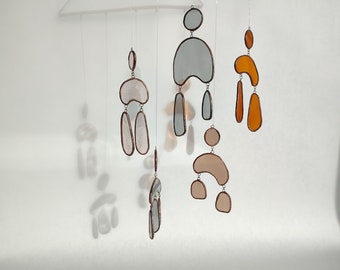 Contemporary wall art. Mobile suspended oval suncatcher in Tiffany stained glass. Window hanging, minimalist light sensor.
