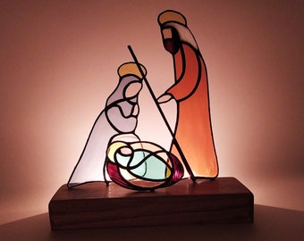 Stained glass nativity representing little Jesus, Mary and Joseph. Minimalist Christmas decoration in a modern and designer style.