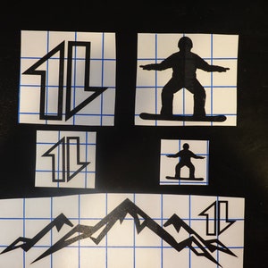 May include: Four black and white stencils on a white grid background. The stencils are of a snowboarder, mountains, and two arrows pointing up and down.