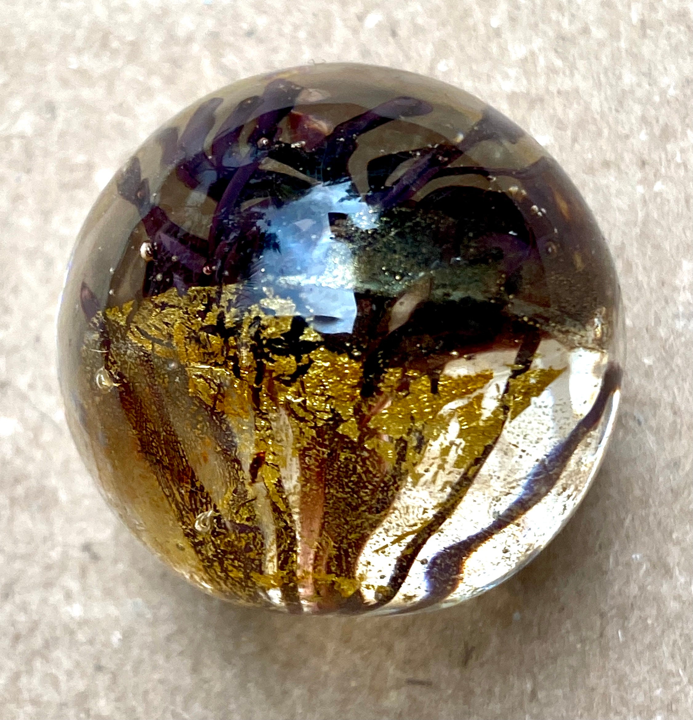 Handmade artisan glass collector's marble of soft glass 104 COE and 22KT gold leaf detail.