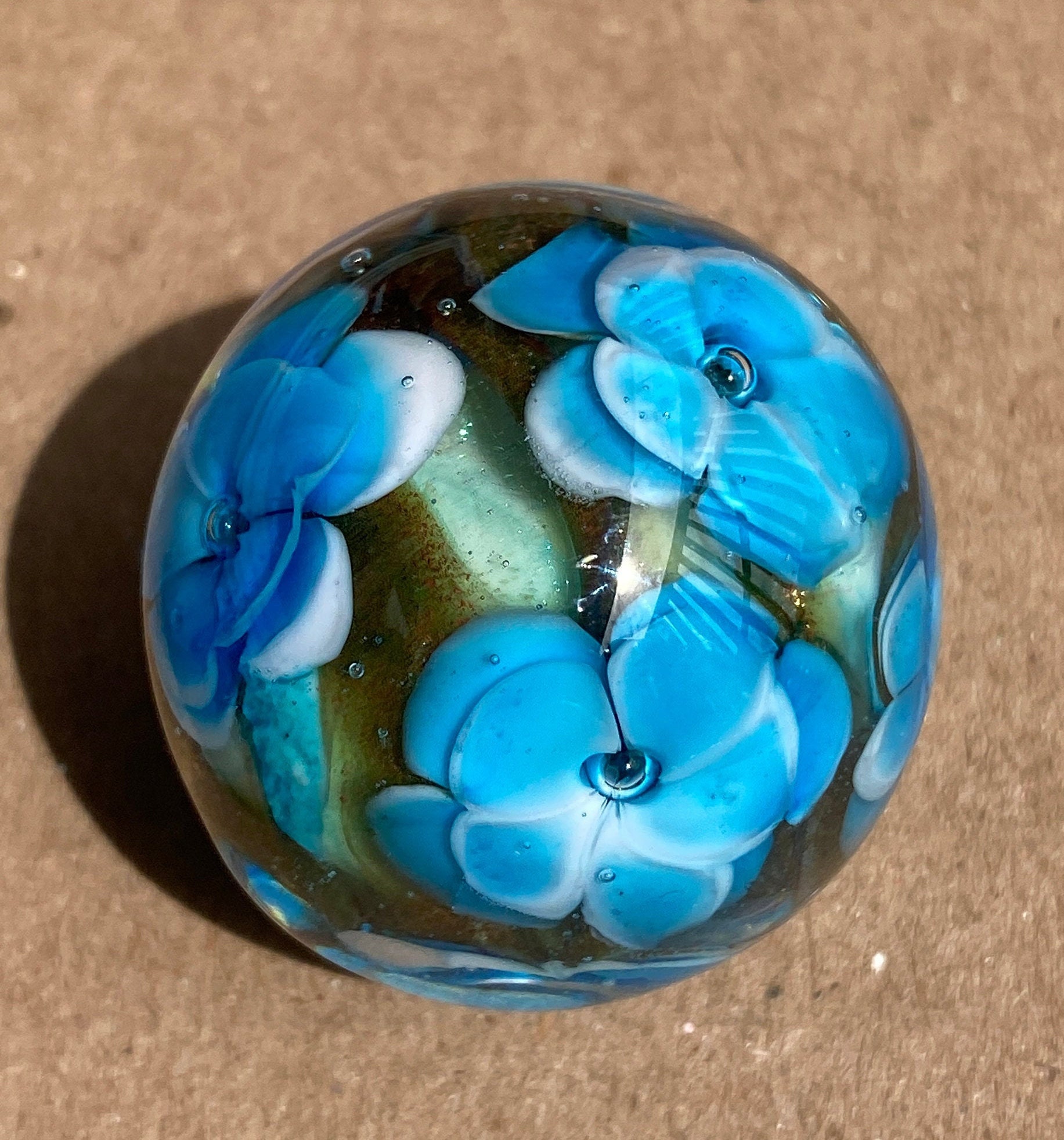 Handmade artisan glass collector's floral marble with airtrap centers