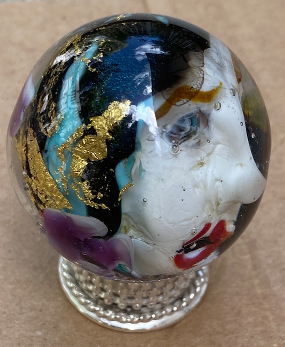 Handmade artisan glass collector's marble head Megan, with blue and gold hair and purple flowers