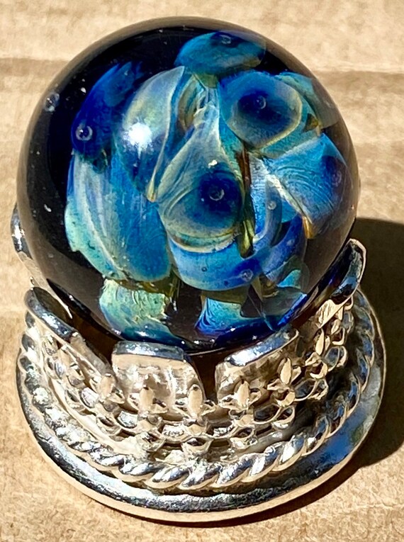 Handmade artisan glass collector's marble with double helix implosion. Handmade sterling silver stand sold separately.