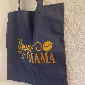 May include: A navy blue tote bag with gold glitter lettering that says "Boujee Mama" and a gold glitter lip print.