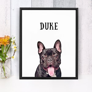 May include: A black and white framed print with the name "DUKE" at the top and a black French Bulldog with a pink tongue sticking out.