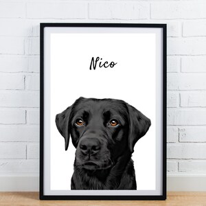 May include: A framed portrait of a black Labrador Retriever with brown eyes. The dog's name, "Nico," is written in cursive above the dog's head. The artwork is displayed in a black frame against a white background.