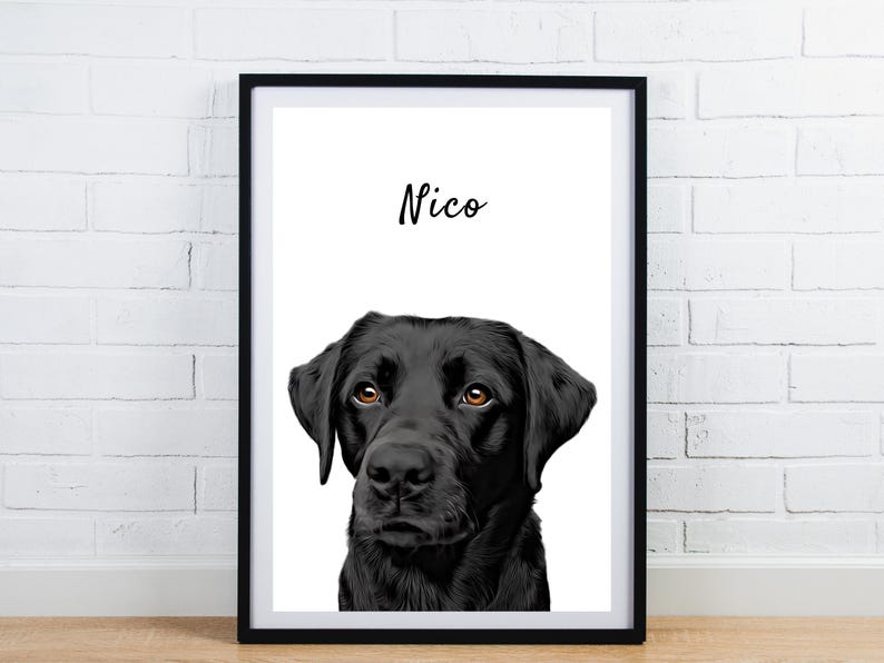 May include: A framed portrait of a black Labrador Retriever with brown eyes. The dog's name, "Nico," is written in cursive above the dog's head. The artwork is displayed in a black frame against a white background.
