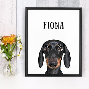 May include: A black and brown dachshund dog with big brown eyes looking directly at the camera. The dog's name, "Fiona", is printed in black text above the dog's head on a white background.