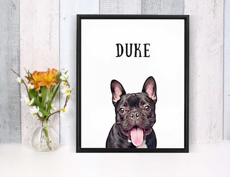 May include: A black and white framed print with the name "DUKE" at the top and a black French Bulldog with a pink tongue sticking out.