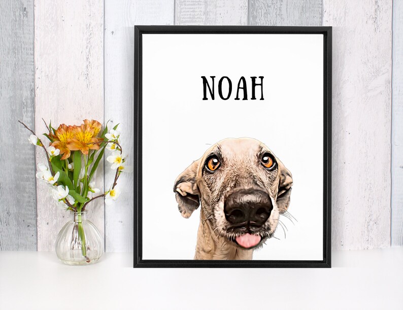 May include: A framed print with a white background featuring a cartoon illustration of a dog with its tongue sticking out. The dog's name, "NOAH", is printed in black at the top of the image.