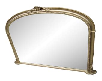 May include: A large, arched gold-painted mirror with a decorative, ornate frame.