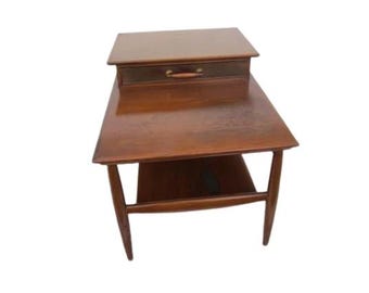 May include: A mid-century modern end table with a single drawer and a lower shelf. The table is made of wood and has a rich brown finish.