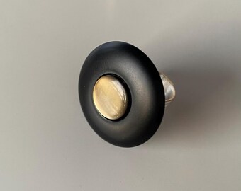 Ira, a black and golden ring, made of two old vintage buttons.
