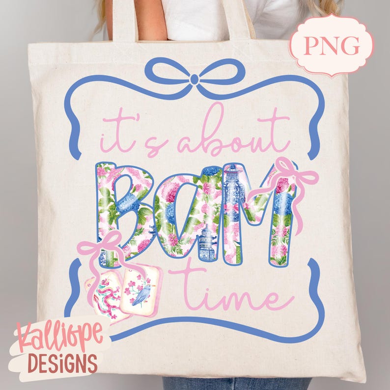 May include: Cream-colored tote bag with the phrase "it's about BAM time" in pink and floral print. The design includes a blue frame with a bow and pink accents. The bag also features the text "Kalliope DESIGNS".