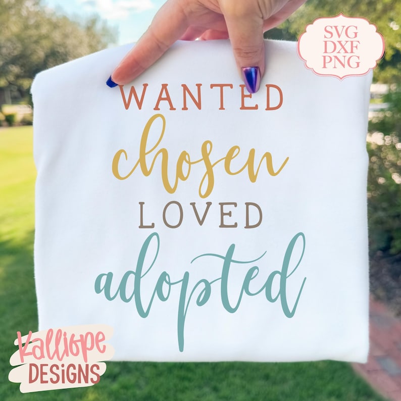 May include: A white t-shirt featuring the words "WANTED, chosen, LOVED, adopted" in shades of orange, gold, brown, and teal. The shirt also has the text "SVG DXF PNG" and the logo "Kalliope DESIGNS".