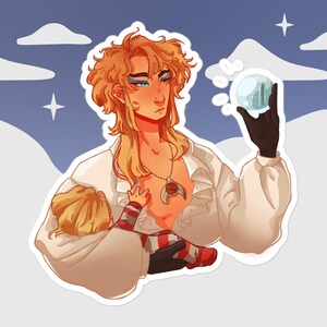 May include: A man with long blonde hair holds a small, clear orb in one hand and a baby in the other. He is wearing a white shirt with a ruffled collar and a gold necklace with a pendant. The baby is wearing a red and white striped onesie. The background is a blue sky with white clouds.