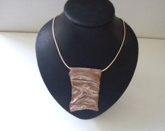 Carry a piece of art with you: unique necklace made of handmade paper.