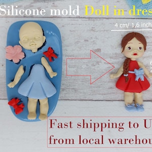 May include: Silicone mould for making a doll in a dress. The mould is blue and has a doll with a blue dress, red bow, and pink flower. The finished doll is 6.5 cm tall and 4 cm wide.