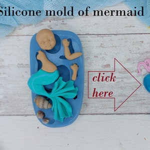 May include: A blue silicone mould of a mermaid with a tail, a seashell, and a starfish. The mould is on a wooden surface. Click here for more information.