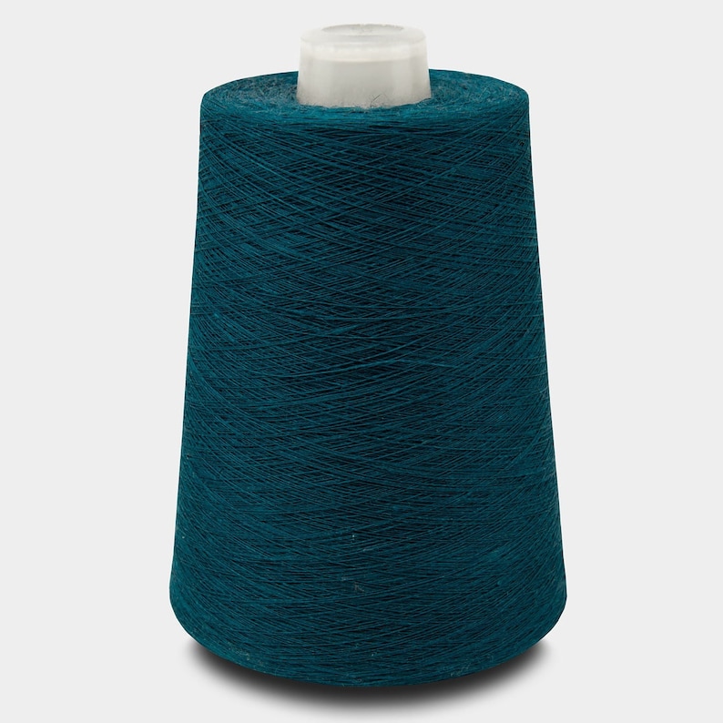May include: A spool of teal blue thread.