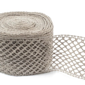 May include: A roll of beige crocheted lace trim with a diamond pattern. The lace is rolled up and a section is unrolled to show the detail.