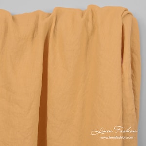 Linen fabric in peach yellow color, washed | width 145cm(57) ± 5%; weight ±210gsm(6.19oz/yd) | made by Siulas, Lithuania
