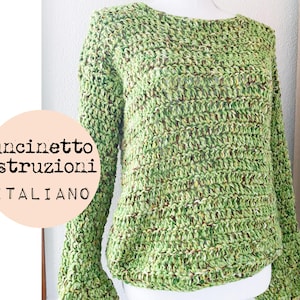 May include: A green crocheted sweater with a textured pattern. The sweater has a round neckline and long sleeves.