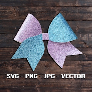 May include: A large, glittery bow with two loops. One loop is light blue and the other is purple. The bow is on a dark brown wooden background.
