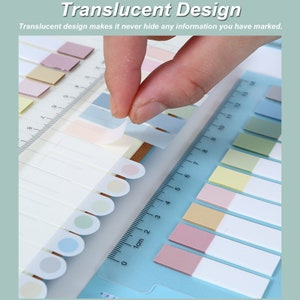 May include: A set of colorful translucent sticky notes with a ruler. The notes are arranged in rows and columns, and the ruler is placed at the bottom of the image. The notes are translucent, so you can see through them to the information underneath. The ruler is marked in centimeters.