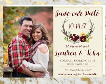 May include: Save the date card with a couple in a fall setting. The card features a rustic design with a floral wreath and antlers. The text reads "Save our Date 10.14.17 for the wedding of Lauren & John Foxhall Sporting Club Douglasville, GA Formal invitation to follow theknot.com/us/huck-mcdevitt"